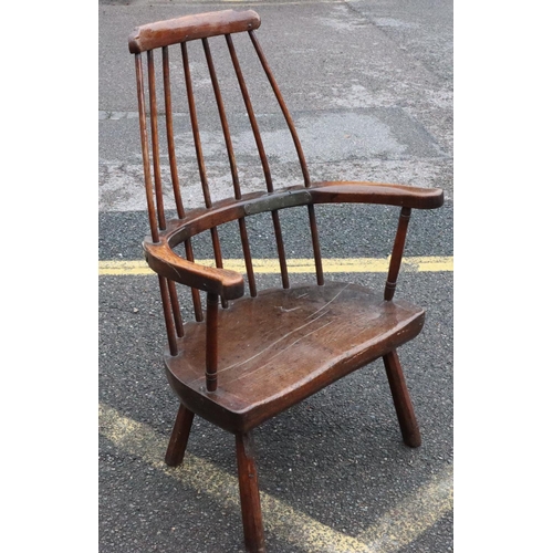 575 - A primitive Welsh stick back armchair with early metal supports to back, thick solid seat, on splaye... 