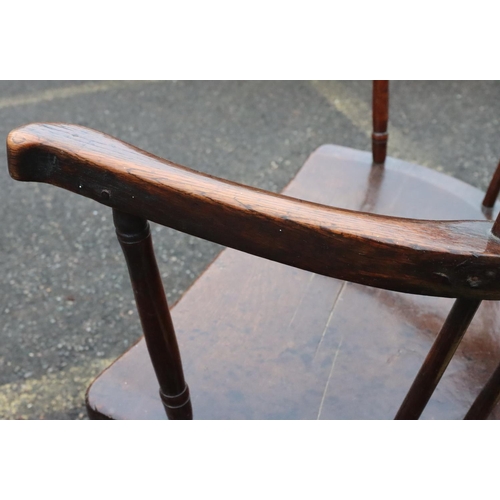 575 - A primitive Welsh stick back armchair with early metal supports to back, thick solid seat, on splaye... 