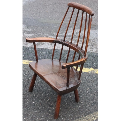 575 - A primitive Welsh stick back armchair with early metal supports to back, thick solid seat, on splaye... 