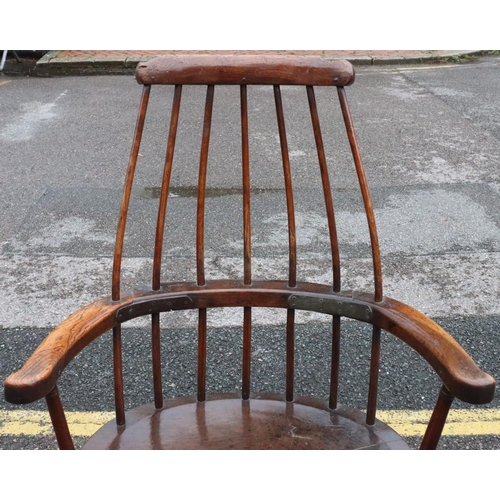 575 - A primitive Welsh stick back armchair with early metal supports to back, thick solid seat, on splaye... 