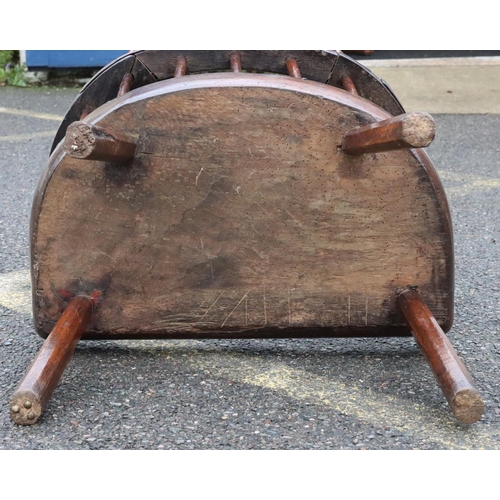 575 - A primitive Welsh stick back armchair with early metal supports to back, thick solid seat, on splaye... 