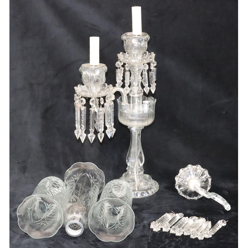 73 - A cut glass 2-branch, 3-light candelabra with 3 trumpet shaped storm shades, on round sweeping base,... 