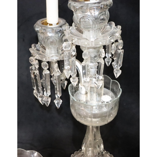 73 - A cut glass 2-branch, 3-light candelabra with 3 trumpet shaped storm shades, on round sweeping base,... 