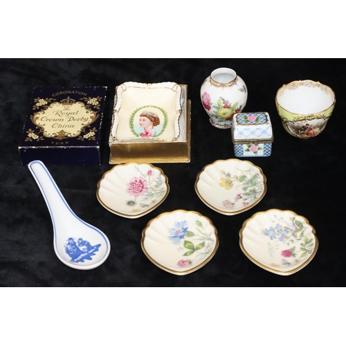 76 - A set of 4 small Continental shell shaped dishes with multi-coloured floral, leaf and gilt decoratio... 