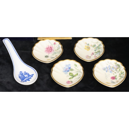 76 - A set of 4 small Continental shell shaped dishes with multi-coloured floral, leaf and gilt decoratio... 