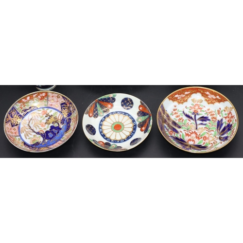 85 - A 19th Century Coalport saucer on Imari patterned ground, another 19th Century saucer, 2 similar cup... 