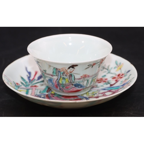 95 - A Chinese tea bowl and saucer on white ground with multi-coloured figure fence and floral decoration... 