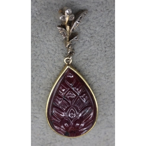 409 - A gold coloured metal drop natural ruby pear shaped pendant, mounted with small diamonds, 5cm high, ... 