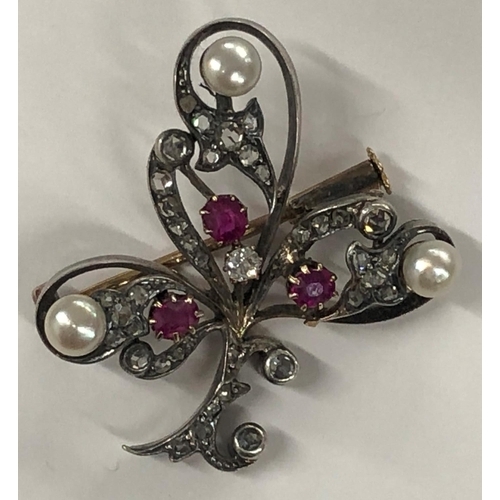 426 - An Asprey gold and silver spray brooch mounted with 3 rubies, 3 half pearls and rough cut diamonds, ... 