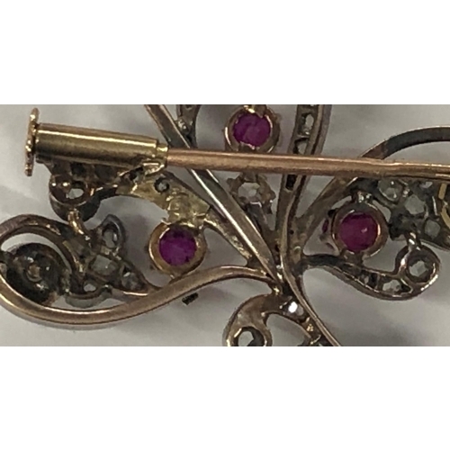 426 - An Asprey gold and silver spray brooch mounted with 3 rubies, 3 half pearls and rough cut diamonds, ... 