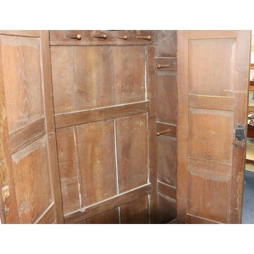 574 - An 18th Century oak cupboard with 2 triple panel doors enclosing hanging pegs, triple panel below, 1... 