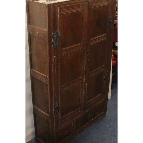 574 - An 18th Century oak cupboard with 2 triple panel doors enclosing hanging pegs, triple panel below, 1... 