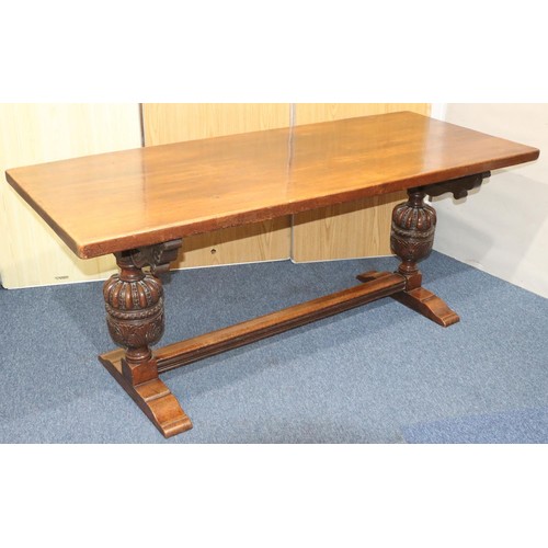 576 - A heavy carved oak refectory table with 2 bulbous supports with carved and leaf decoration, centre s... 