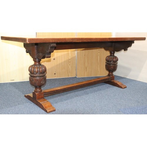 576 - A heavy carved oak refectory table with 2 bulbous supports with carved and leaf decoration, centre s... 