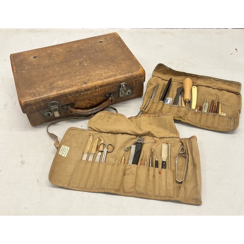 514 - 2 canvas rolls of medical and other instruments and a small leather attaché case, 37cm wide