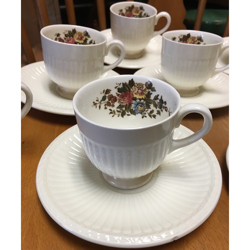 9145 - A Wedgwood coffee service on cream ground with multi-coloured floral and leaf decoration, comprising... 