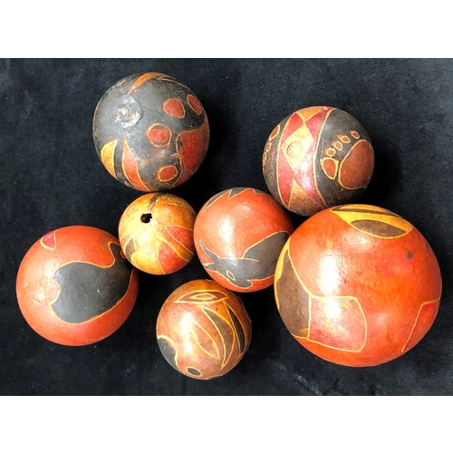 9004 - 7 hand painted aboriginal seed balls, largest 9cm diameter and a metal fruit basket.