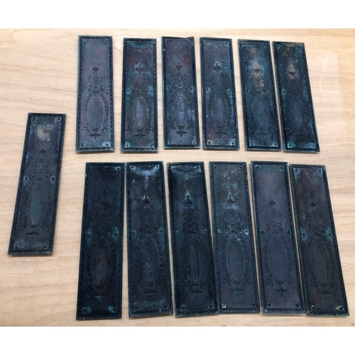 9288 - A set of 13 brass door plates, 28.5cm x 7.5cm, each with 6 screw holes (1 corner slightly bent).