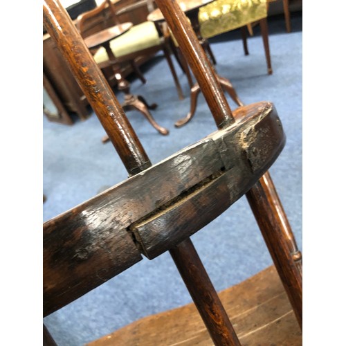 575 - A primitive Welsh stick back armchair with early metal supports to back, thick solid seat, on splaye... 