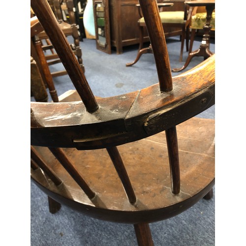 575 - A primitive Welsh stick back armchair with early metal supports to back, thick solid seat, on splaye... 