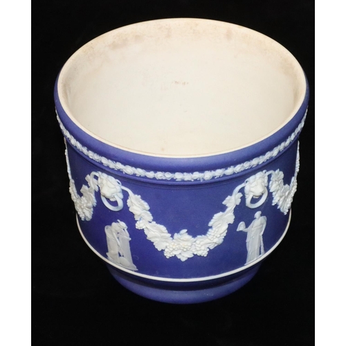 5 - A Wedgwood Jasperware round jardinière on blue and white ground with raised grape, vine, swag and fi... 