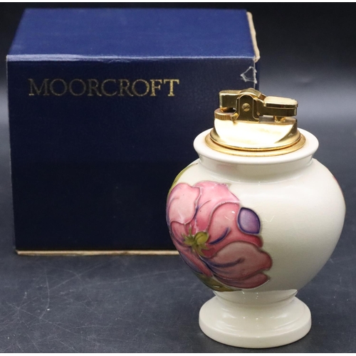 26 - A Moorcroft round bulbous shaped table lighter on cream ground with multi-coloured floral and leaf d... 