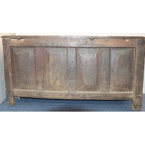 570 - An 18th Century oak coffer with 4 panelled front, part hinged lid (original hinges but no lock), on ... 