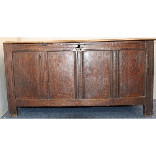 570 - An 18th Century oak coffer with 4 panelled front, part hinged lid (original hinges but no lock), on ... 