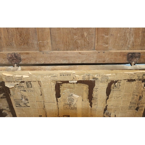 570 - An 18th Century oak coffer with 4 panelled front, part hinged lid (original hinges but no lock), on ... 