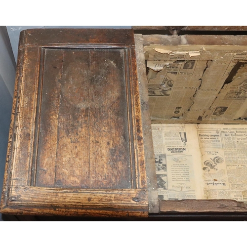 570 - An 18th Century oak coffer with 4 panelled front, part hinged lid (original hinges but no lock), on ... 