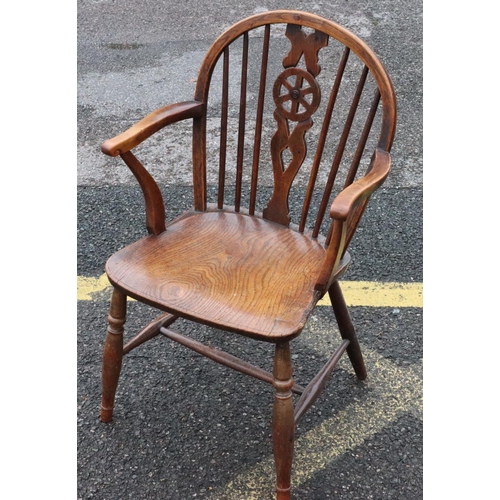 571 - A 19th Century yew and elm wheel and stick back armchair with solid seat on round turned legs and st... 