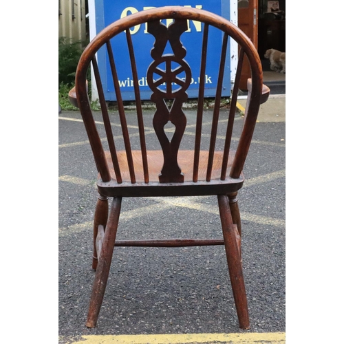 571 - A 19th Century yew and elm wheel and stick back armchair with solid seat on round turned legs and st... 