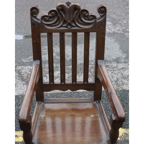 572 - An 18th and later Century oak narrow armchair with fluted stick back with carved scroll decoration, ... 