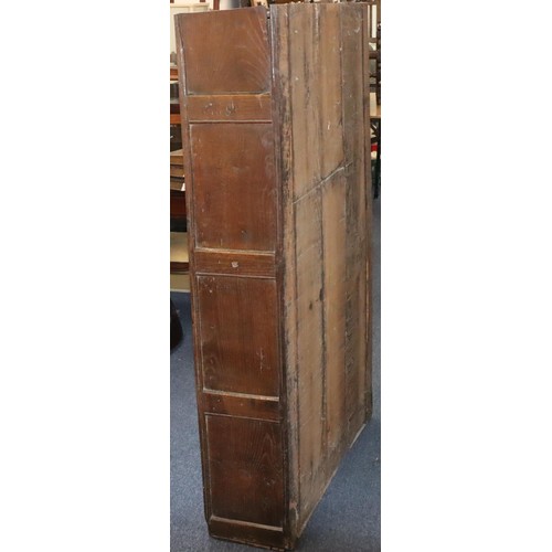 574 - An 18th Century oak cupboard with 2 triple panel doors enclosing hanging pegs, triple panel below, 1... 