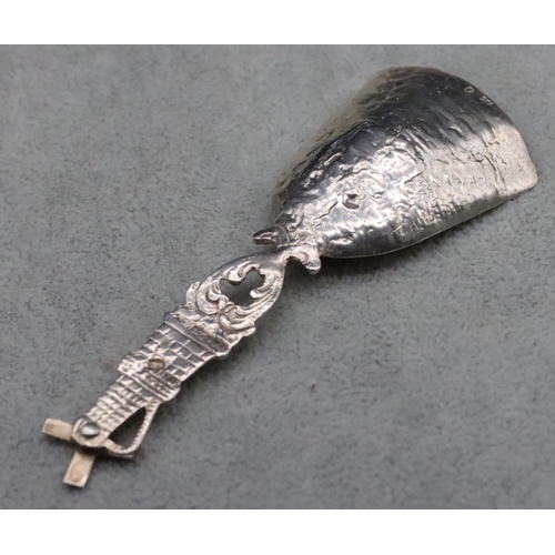 221 - A 935 Dutch silver caddy spoon with windmill motif with allover embossed figure decoration, 10cm lon... 