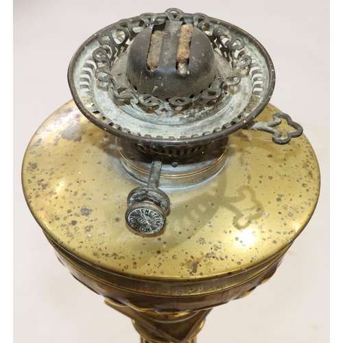 450 - A brass Corinthian column paraffin lamp with bulbous shaped bowl and embossed decoration, on square ... 