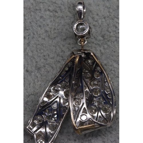 410 - A platinum Art Deco style ribbon shaped drop pendant mounted with allover diamonds, 4.3cm high, 4.3 ... 