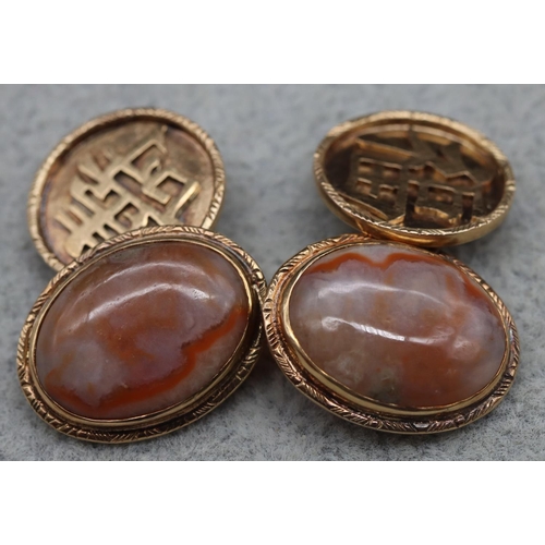 412 - A pair of Chinese gold and red jadeite oval gentlemen's cufflinks, 8.1 grams gross