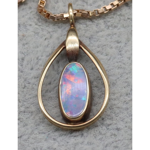 413 - A gold oval black opal pendant with square 9ct gold chain, 4.9 grams gross