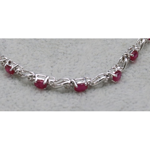 415 - A 14ct white gold bracelet set with small rubies and diamonds, 18.3cm long, 6.2 grams gross