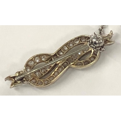 425 - A gold and platinum ribbon brooch inset with diamonds, 3.5cm wide, 4.1 grams gross