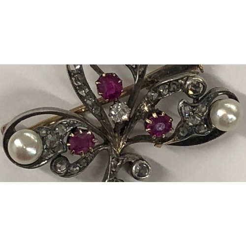 426 - An Asprey gold and silver spray brooch mounted with 3 rubies, 3 half pearls and rough cut diamonds, ... 