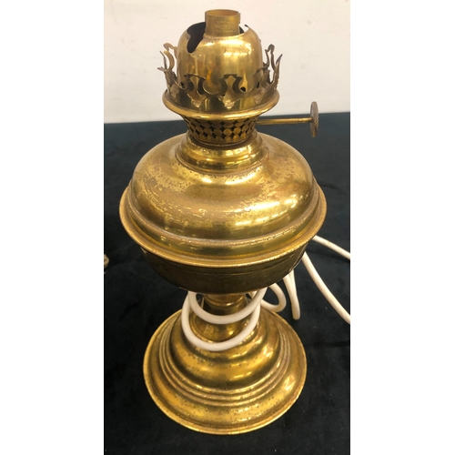 1008 - A pair of metallic hanging paraffin lamps converted to electricity, 64cm overall and another brass p... 