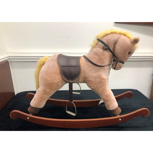 1011 - A Lefray Designs Ltd plush rocking horse on wood base, 65cm high overall.