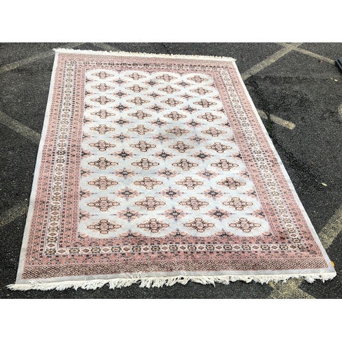 1016 - A modern Persian rug on cream and pale grey/blue ground, 188 x 277cm.