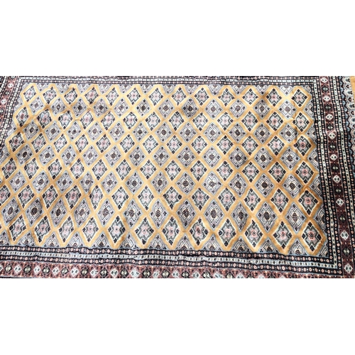 1017 - A modern Persian rug on yellow/mustard and beige ground, 273 x 188cm.