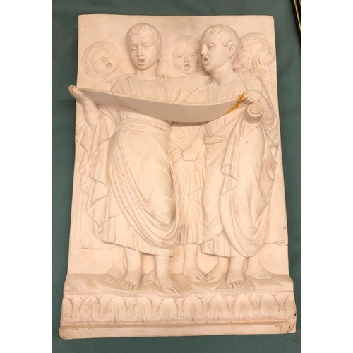 1043 - A plaster wall plaque of a group of young Roman boys singing, indistinctly stamped to reverse, numbe... 