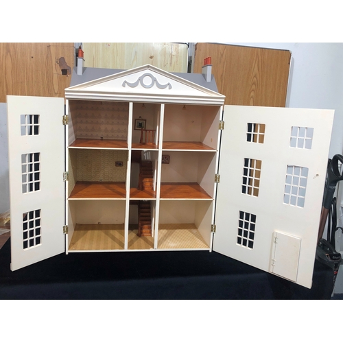 1054 - A large, good quality 3 storey dolls house with hinged opening front and decorated interior, 89cm hi... 