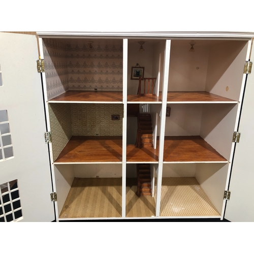 1054 - A large, good quality 3 storey dolls house with hinged opening front and decorated interior, 89cm hi... 