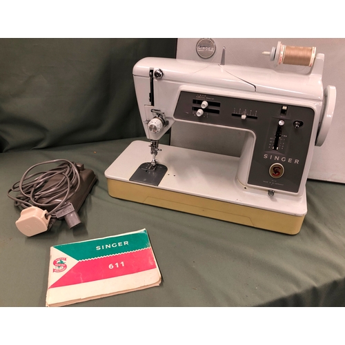 1074 - A Singer 611 G sewing machine with power cable, pedal and manual, in hard carrying case.